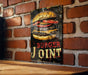 a sign on a brick wall that says burger joint