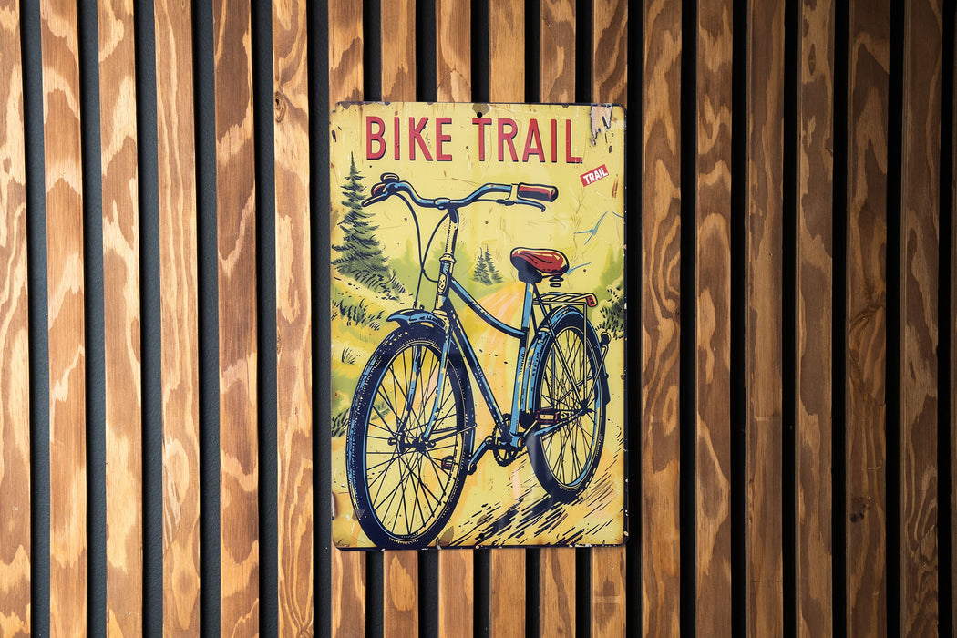 a bicycle trail sign on a wooden wall