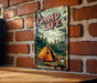 a picture of a camp life sign on a brick wall