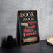 a book nook sign sitting on top of a table