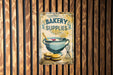 a wooden wall with a sign that says bakery supplies