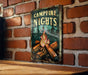 a picture of a campfire nights sign on a brick wall