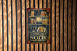 a library sign hanging on a wooden wall