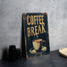 a sign that says coffee break on a table