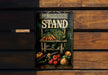 a picture of a produce stand on a wooden wall