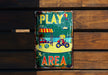 a sign on a wooden wall that says play area