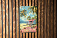a painting of a beach hut on a wooden wall