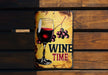 a metal sign with a glass of wine on it