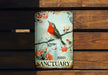 a bird sanctuary sign on a wooden bench