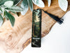 a bookmark with a picture of a forest on it
