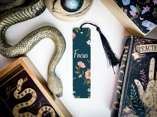 a bookmark with a snake on it next to other books