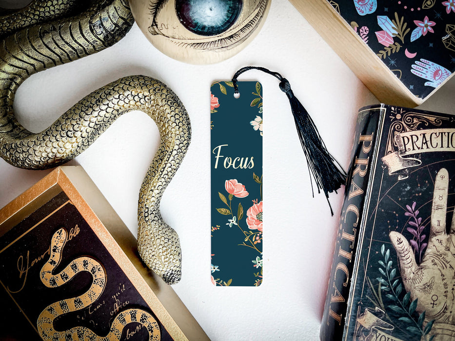 a bookmark with a snake on it next to other books