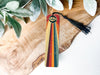 a piece of wood with a tassel hanging from it