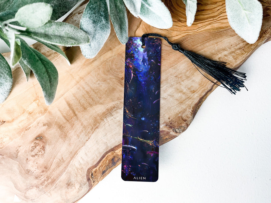 a bookmark with a tassel on top of a piece of wood