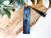 a bookmark with a picture of a man standing on a cliff
