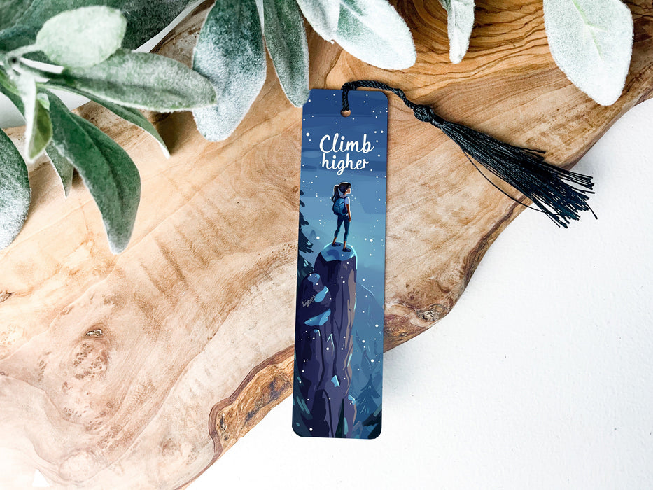 a bookmark with a picture of a man standing on a cliff