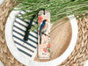 a bookmark with a bird on it sitting on a plate