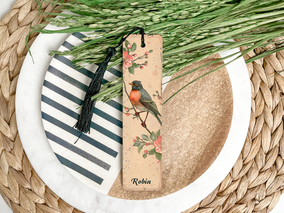 a bookmark with a bird on it sitting on a plate