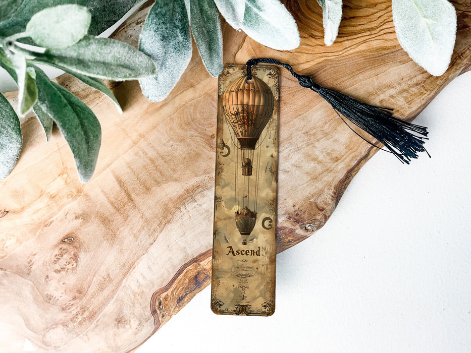 a wooden clock with a tassel hanging from it