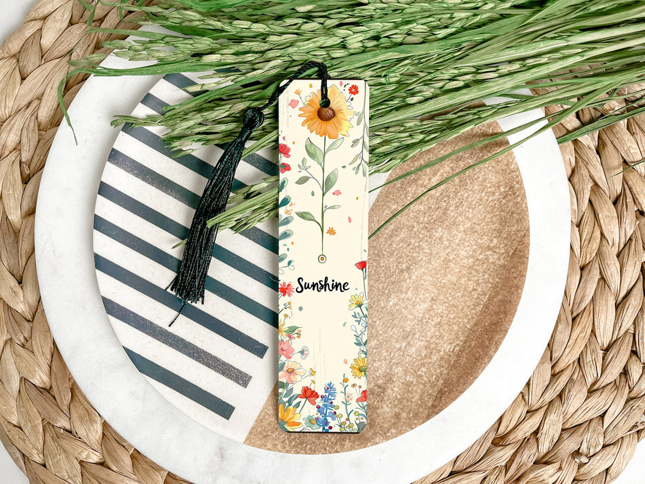 a bookmark sitting on top of a plate next to a plant