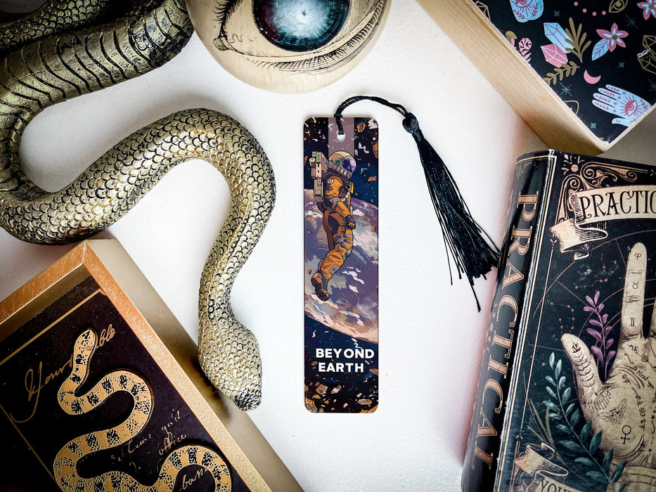 a bookmark with a snake on it next to other books