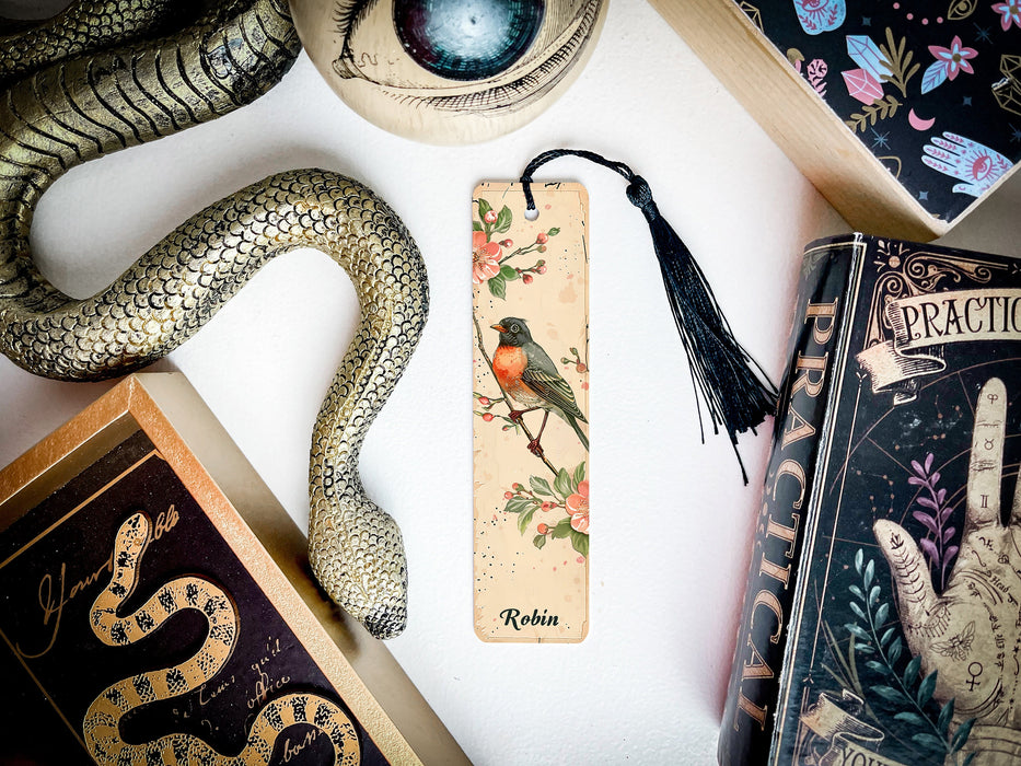 a bookmark with a bird on it next to a snake
