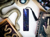 a bookmark, snake, and other items on a table