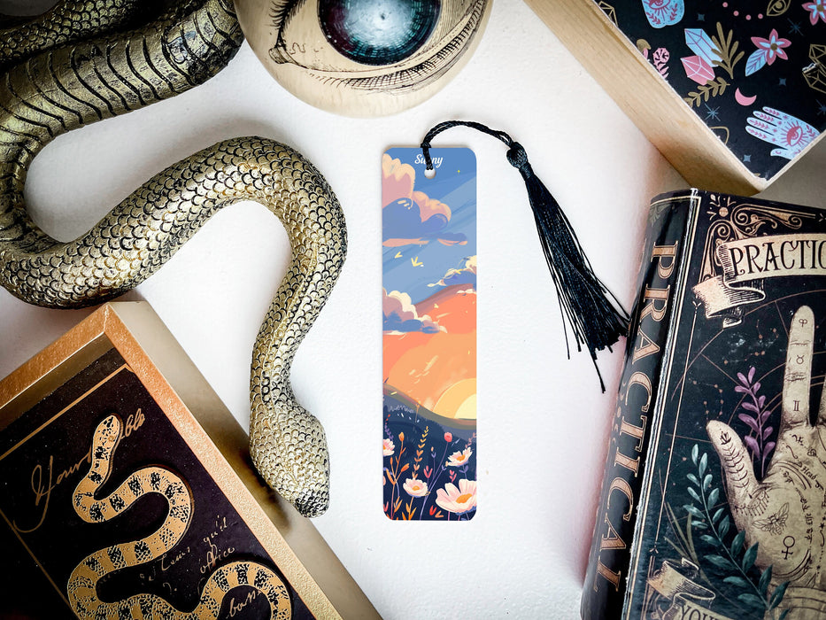 a bookmark with a snake on it next to other books