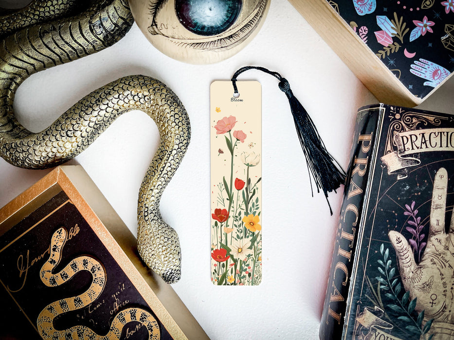 a bookmark with a snake and flowers on it