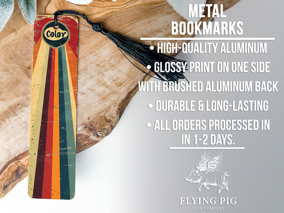 a metal bookmark with a tassel hanging from it
