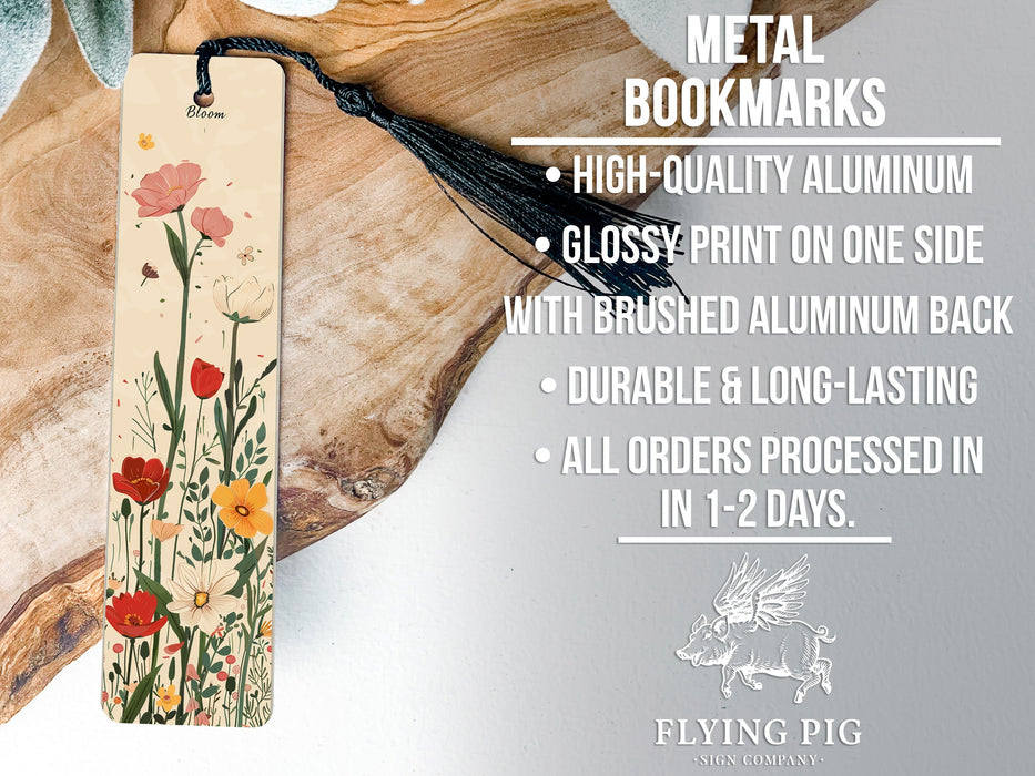 a bookmark with flowers on it sitting on a piece of wood