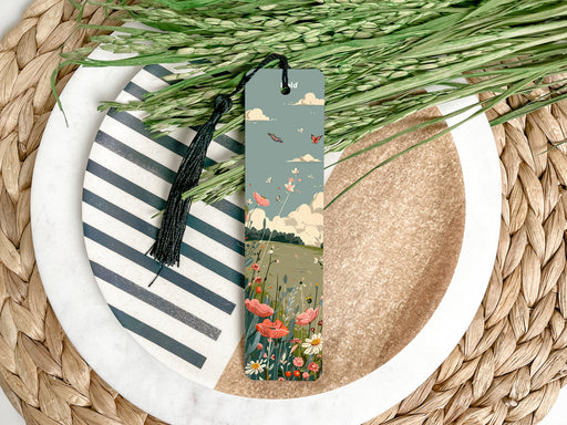a bookmark on a plate with flowers and grass