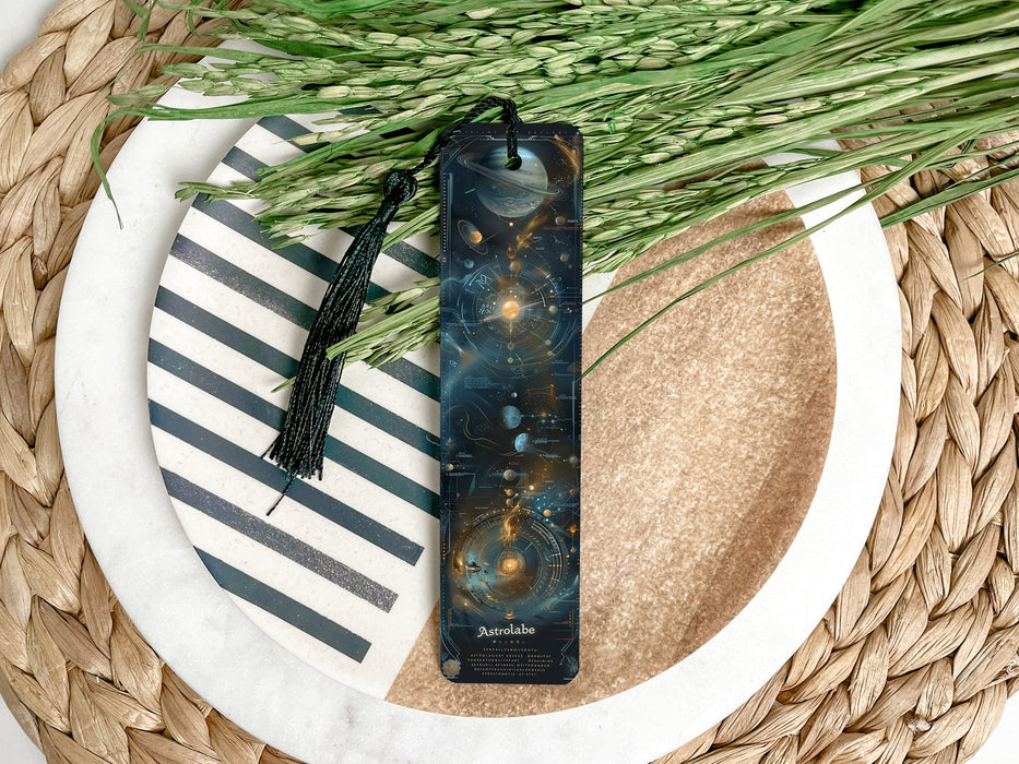 a bookmark sitting on top of a table next to a plant