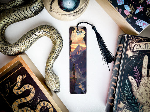 a bookmark with a snake on it next to other books