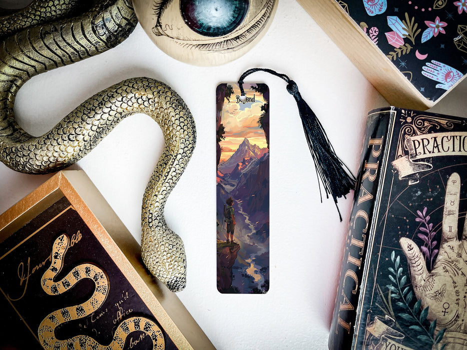 a bookmark with a snake on it next to other books