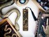 a snake, bookmark, and other items are on a table