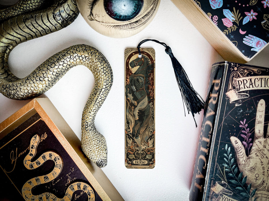 a snake, bookmark, and other items are on a table