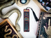 a snake, a bookmark, and other items on a table