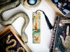 a bookmark, snake, and other items on a table