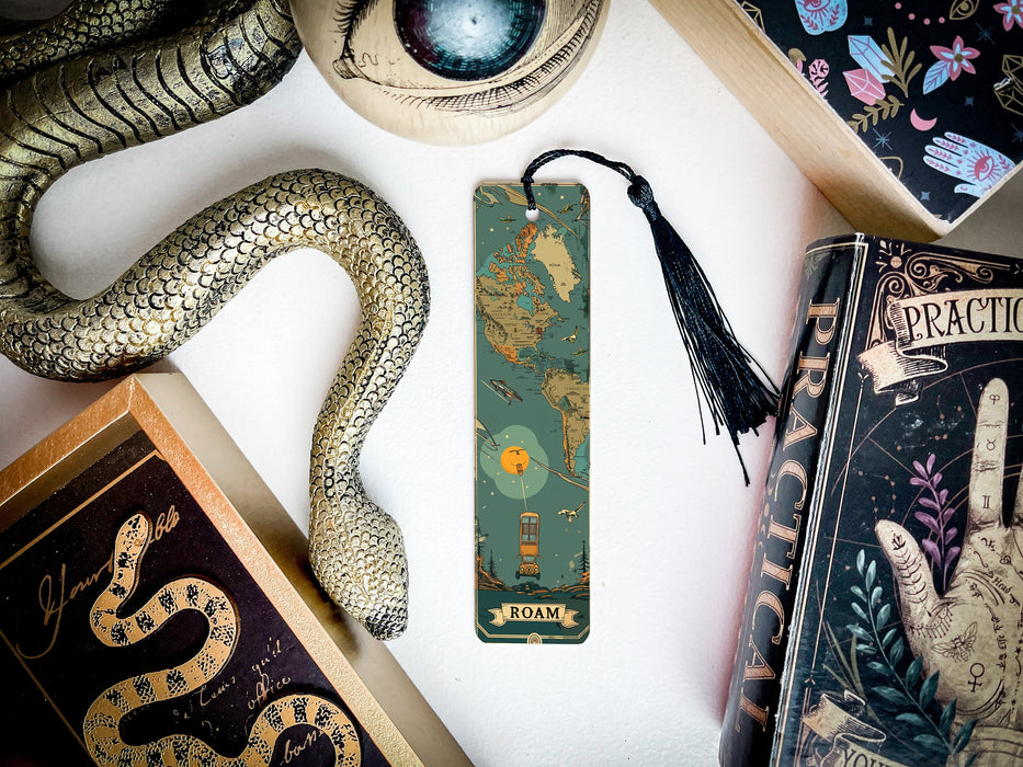 a bookmark with a snake on it next to other books