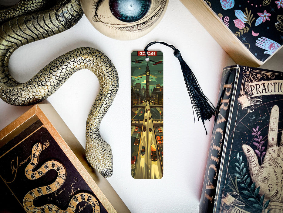 a bookmark with a snake and a book on it