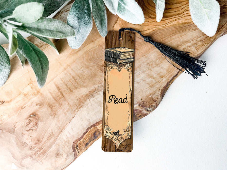 a wooden bookmark with a tassel on top of it