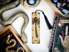 a snake, a bookmark, and other items on a table