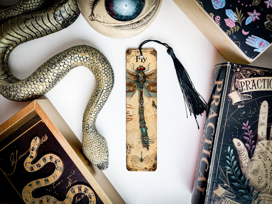 a snake, a bookmark, and other items on a table