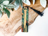 a piece of wood with a tassel on it