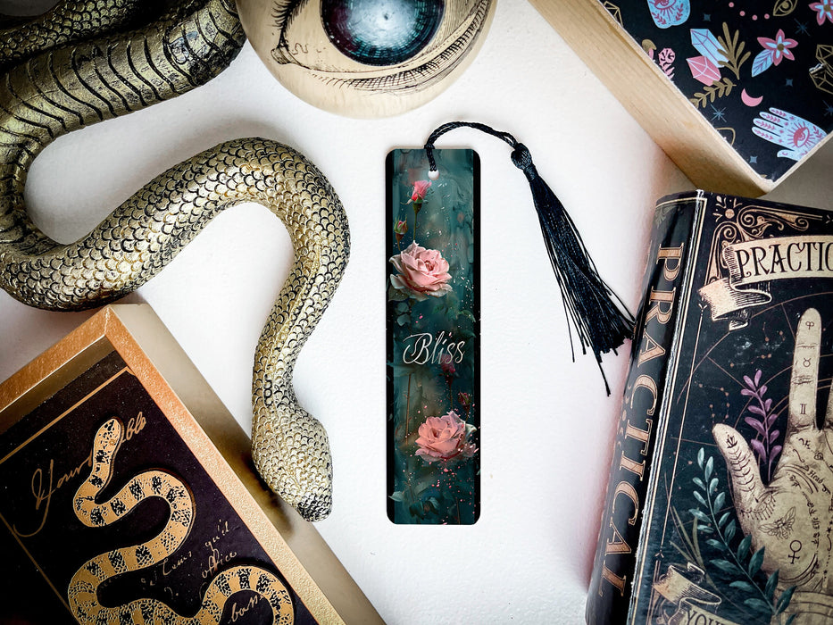 a bookmark with a snake and flowers on it
