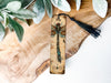 a wooden plaque with a dragonfly on it