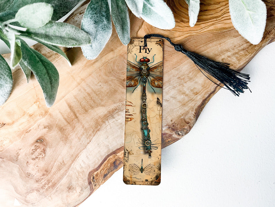 a wooden plaque with a dragonfly on it