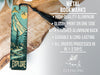 a metal bookmark with a mountain scene on it