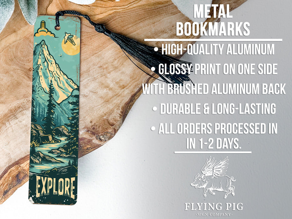 a metal bookmark with a mountain scene on it